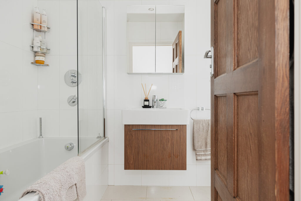 White bathroom with wood accents 